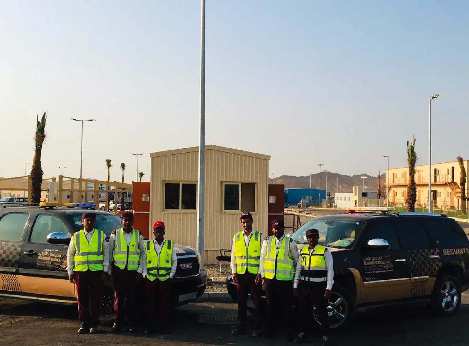 Security team with high-visibility vests at a remote project gate